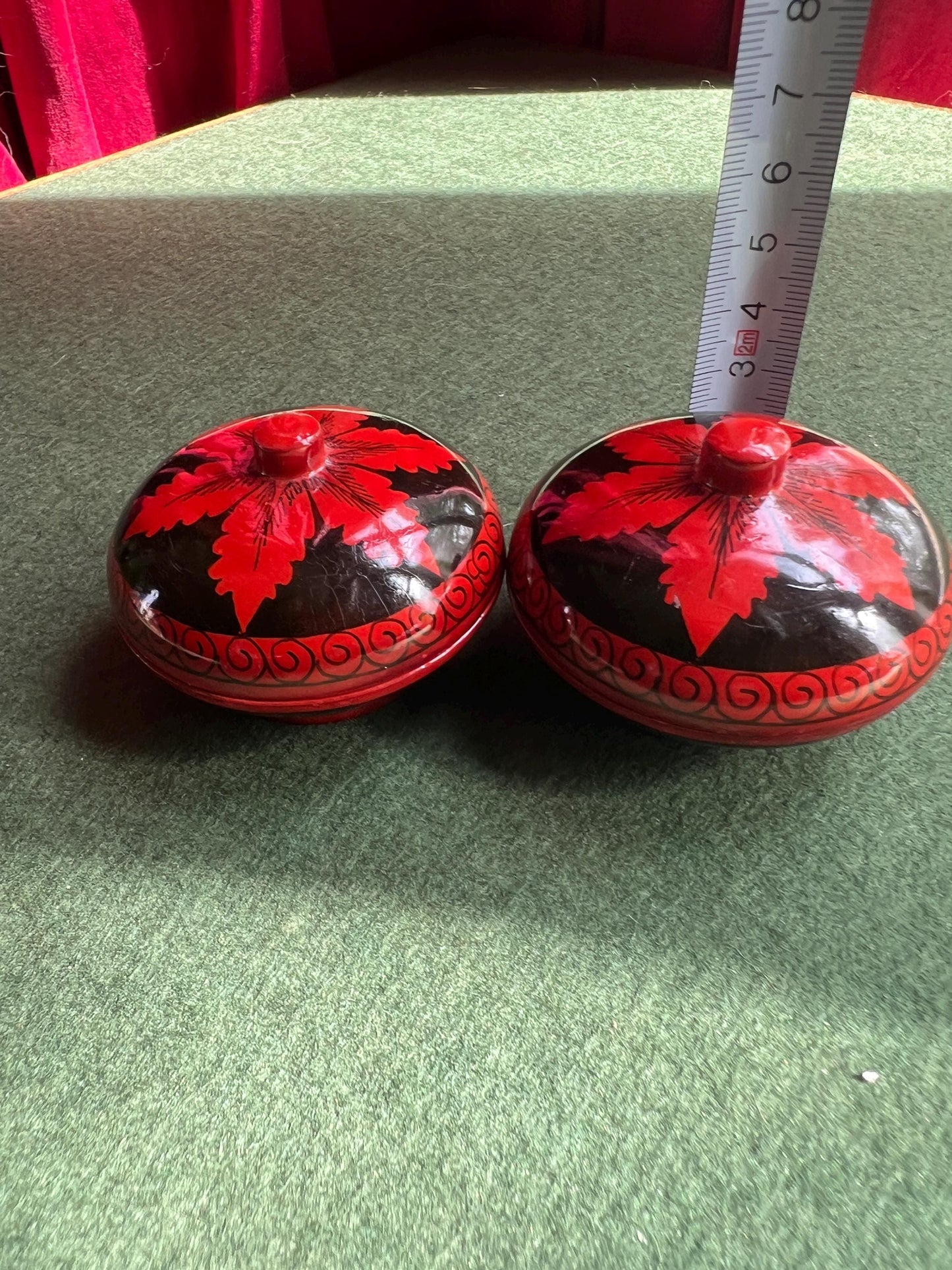 Pair of red and black lacquered lidded boxes. Tiny trinket ring boxes. Sold as a pair.