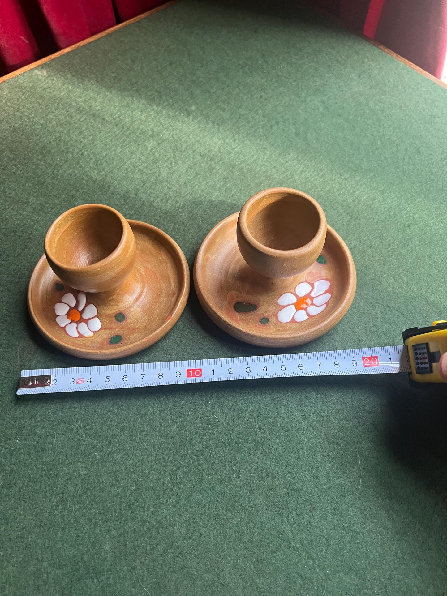 Pair of ceramic egg cups. Studio pottery brown glazed egg cups with integral saucers,
