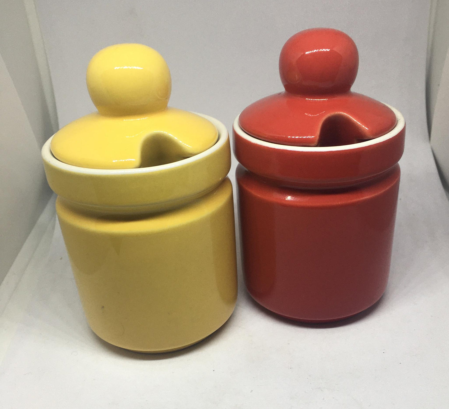 Ceramic lidded honey sugar pots. Vibrant red and yellow glazed set of vintage jam pots.