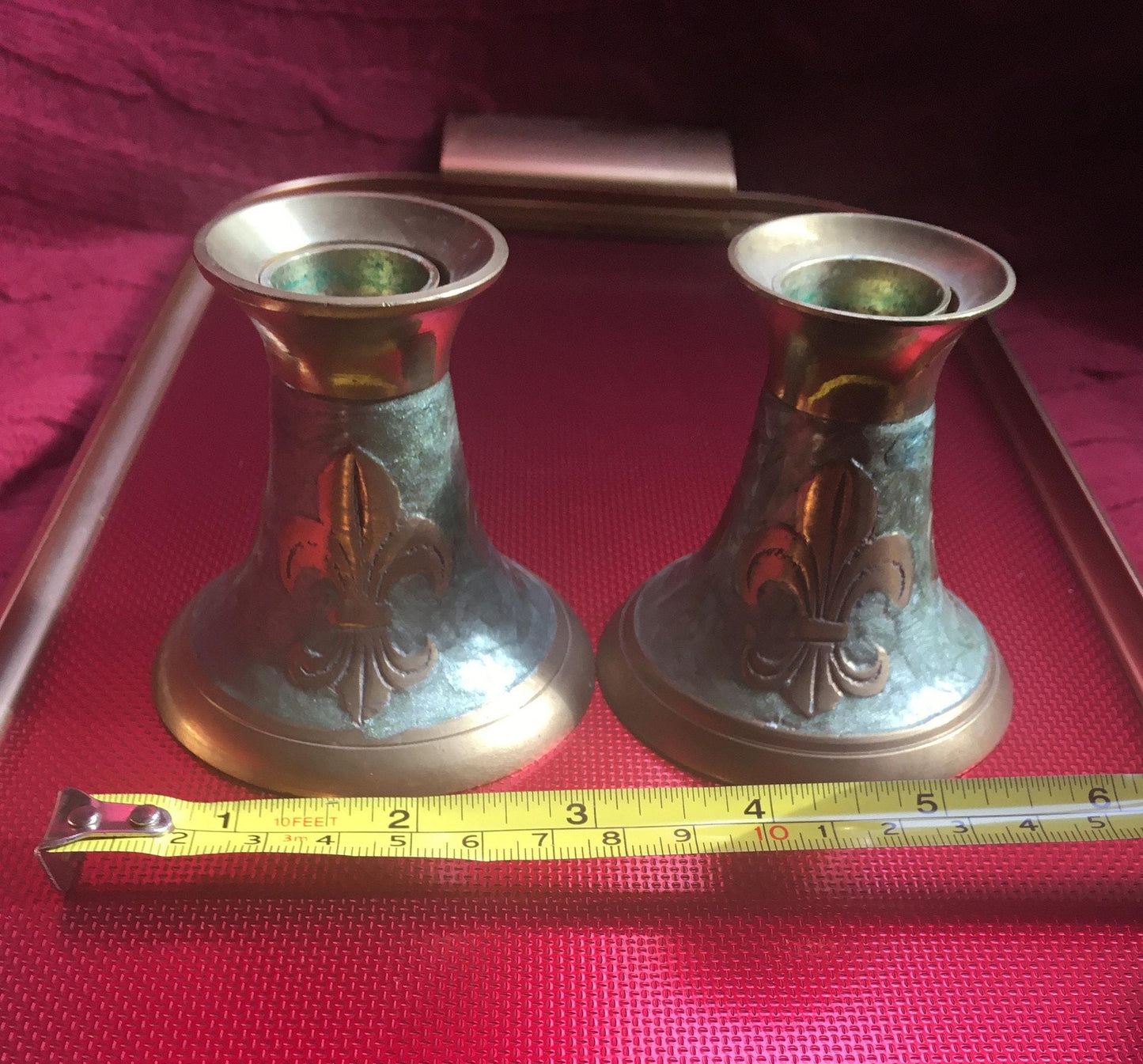 Pair of brass and green enamel candlesticks. Green enamel Fleur de Lis design.