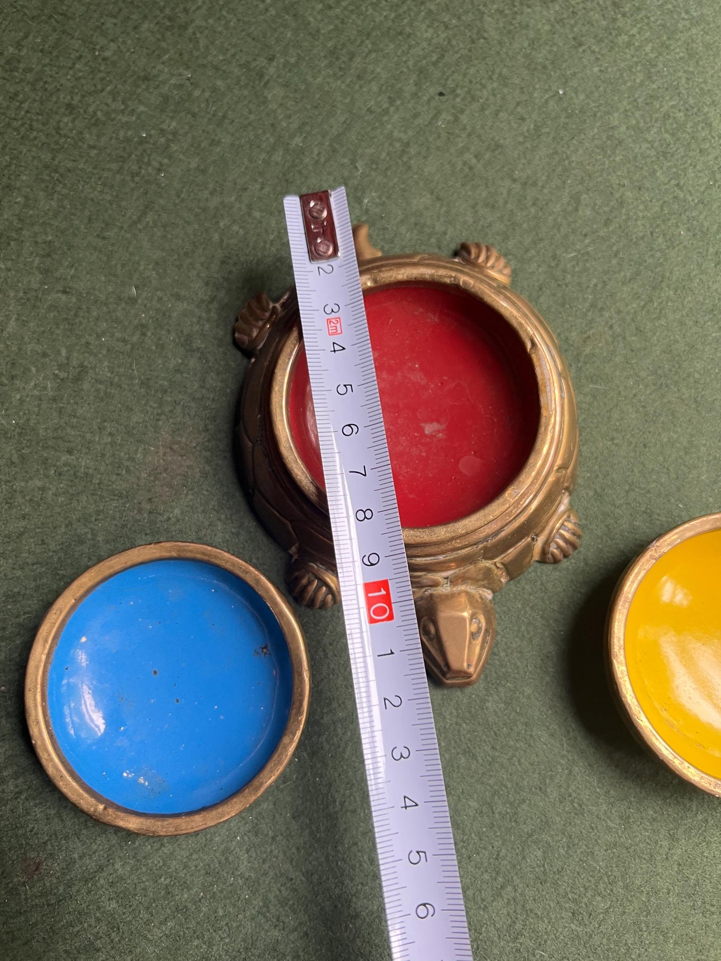 Quirky enamel brass stacking ashtrays on tortoise base.