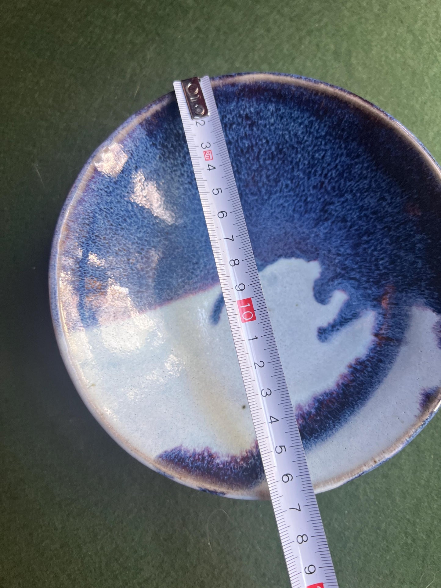 Studio pottery bowl. Hand thrown stone ware with blue white drip glaze. Signed footed bowl.
