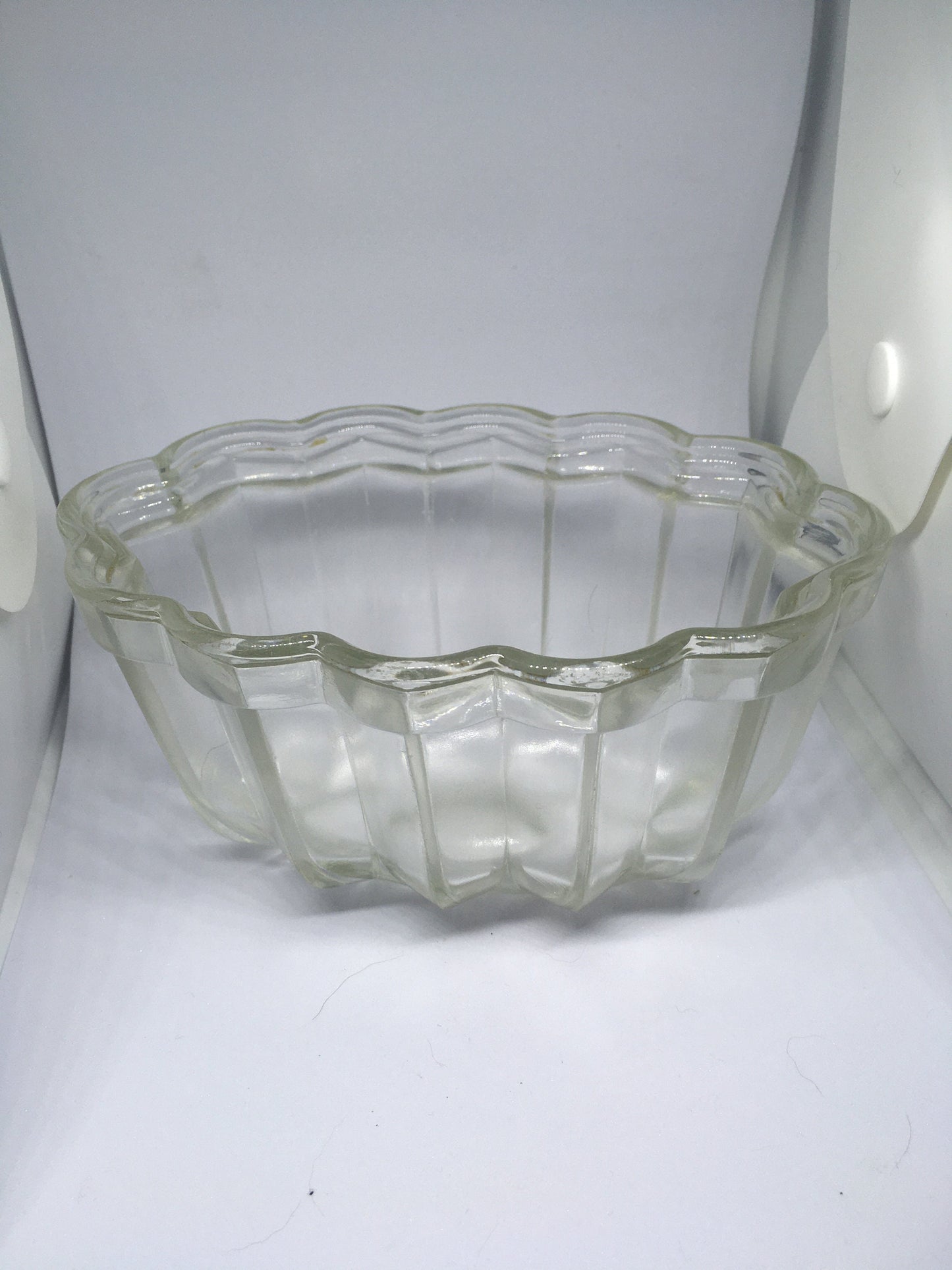 Vintage glass jelly mould. Clear pressed glass with scalloped edge. 10cm deep 16cm long.