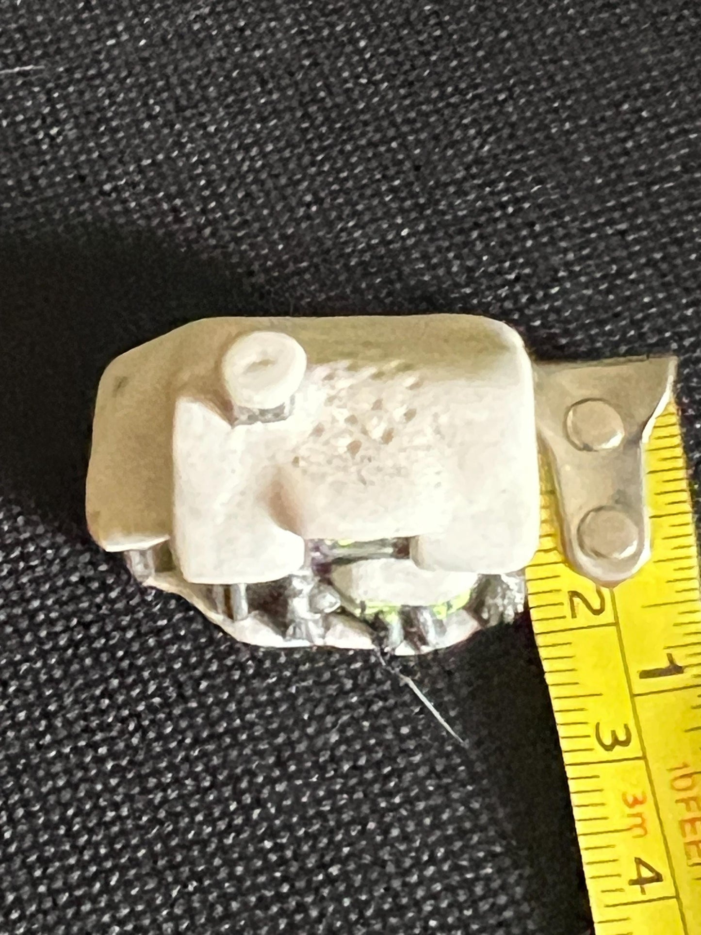 Miniature solid metal cast ornament snow covered Victorian shop.