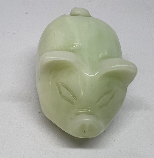 Vintage jade pig figurine. Cute carved white stone jade piglet ornament.