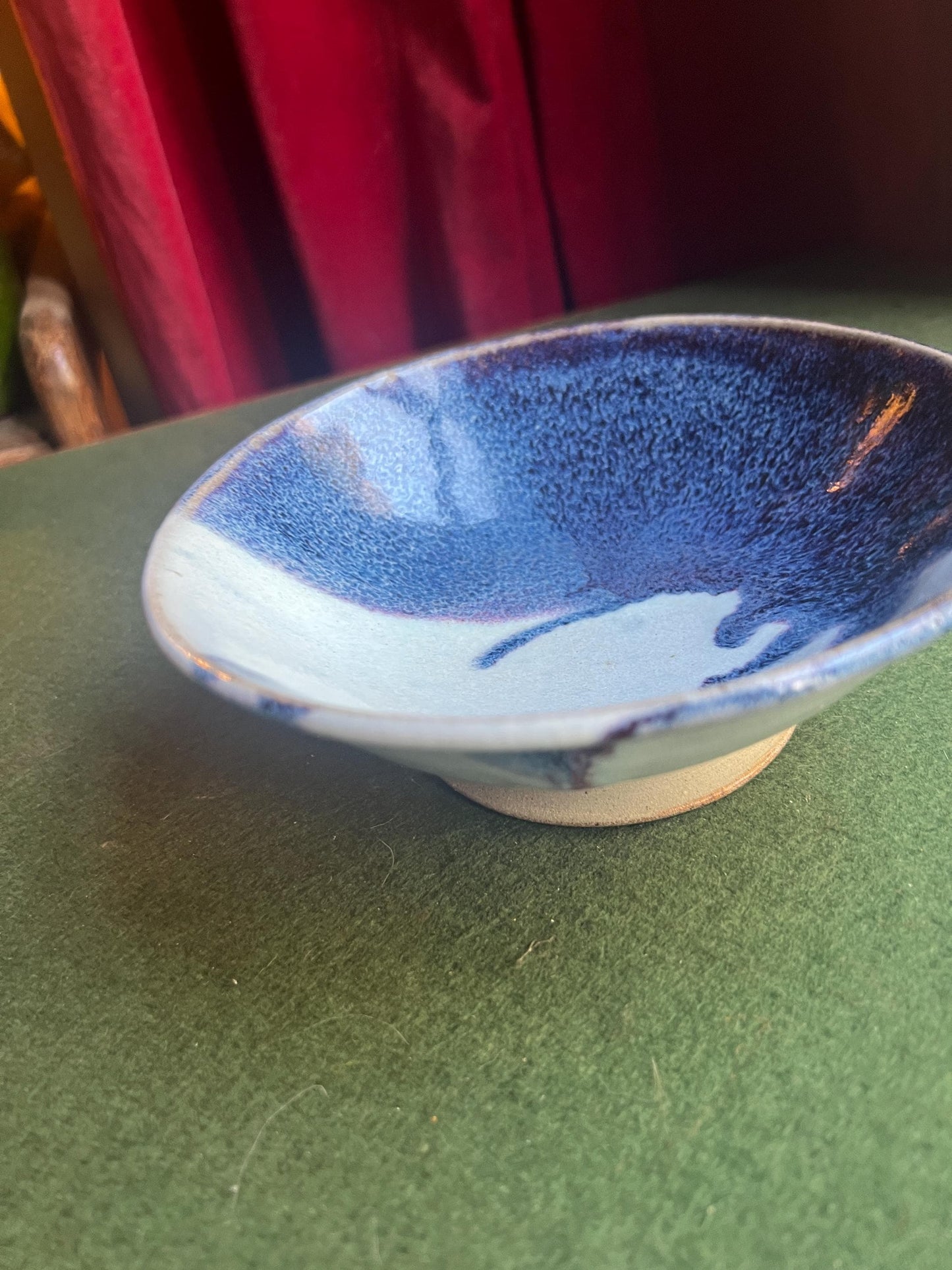 Studio pottery bowl. Hand thrown stone ware with blue white drip glaze. Signed footed bowl.