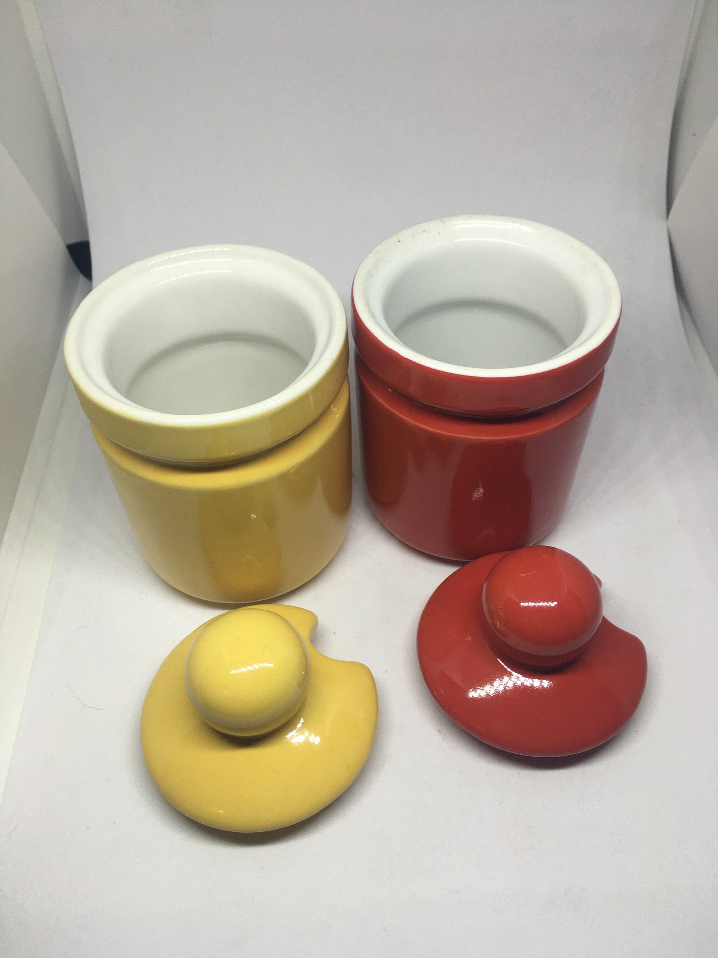 Ceramic lidded honey sugar pots. Vibrant red and yellow glazed set of vintage jam pots.
