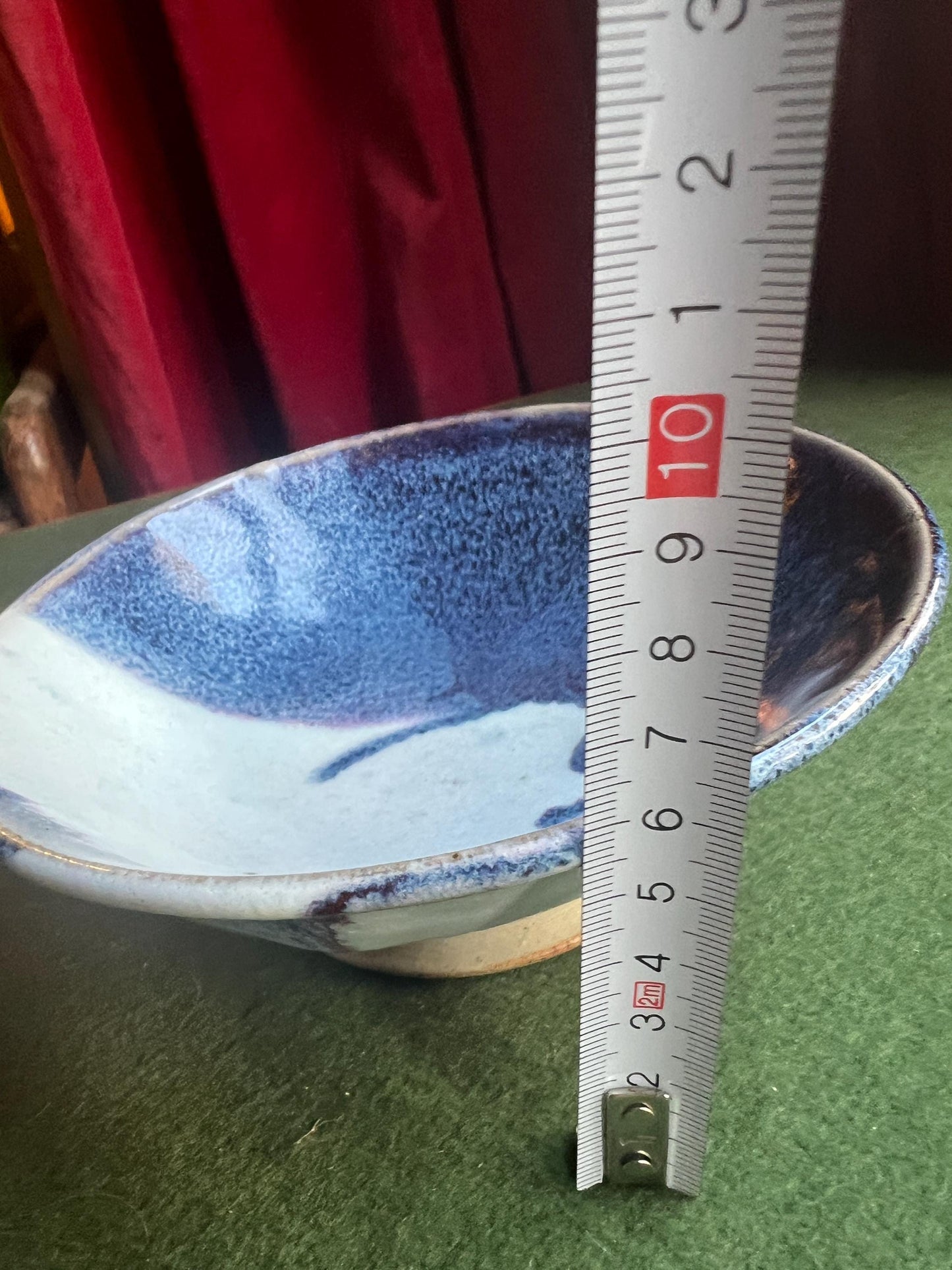 Studio pottery bowl. Hand thrown stone ware with blue white drip glaze. Signed footed bowl.
