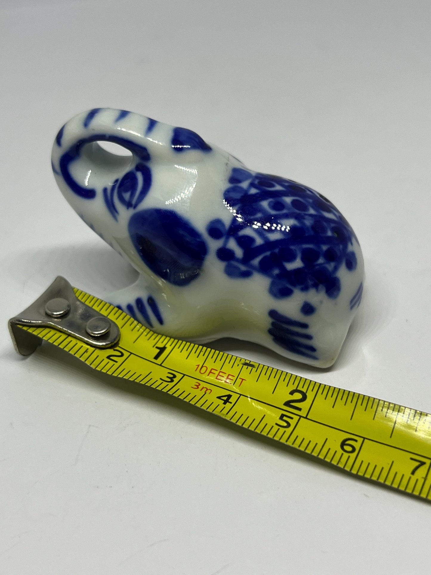 Blue white ceramic elephant figurine. Lucky trunk up sitting elephant ornament.