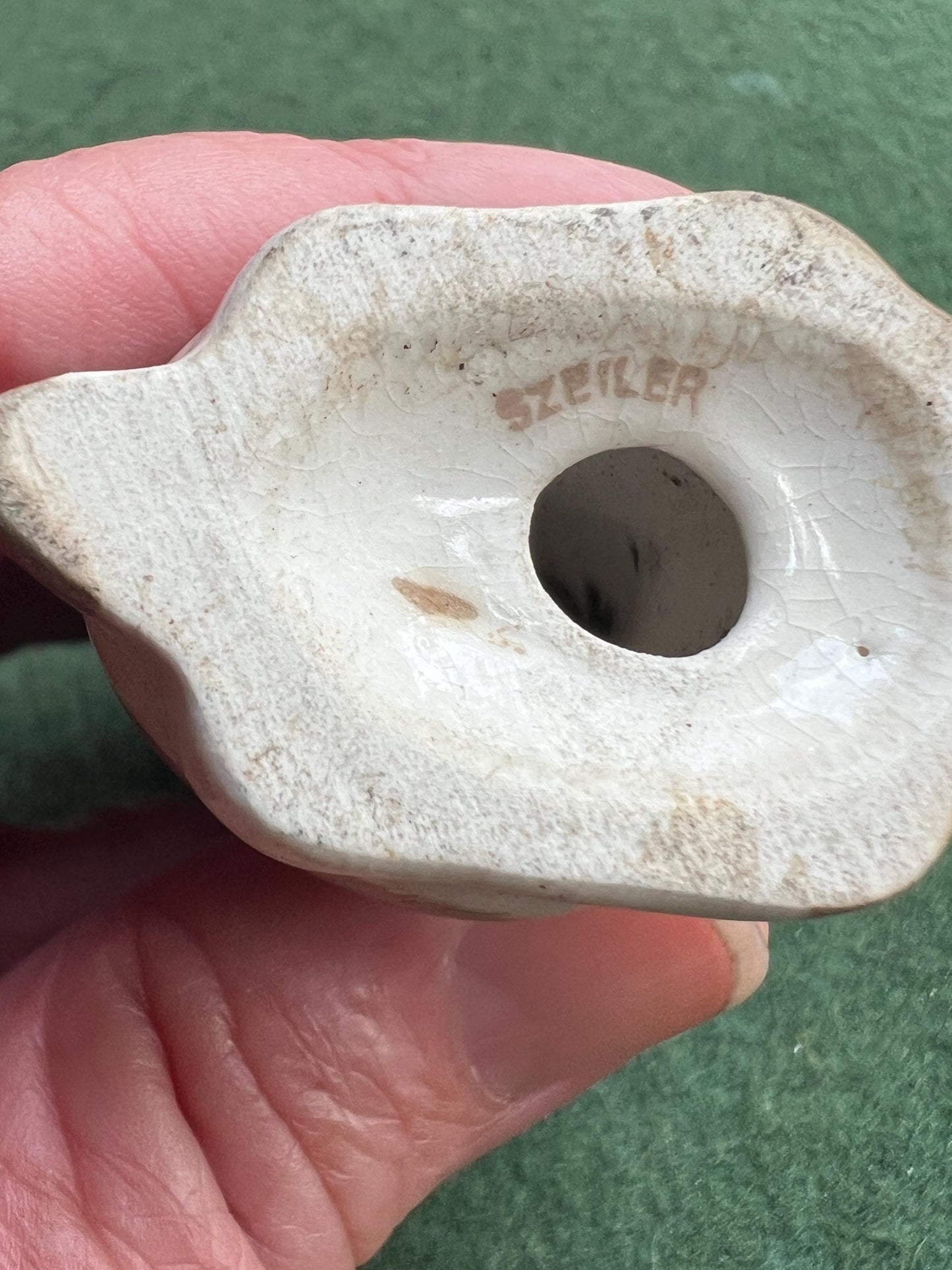 Ceramic sad hound dog figurine. Stamped Szeiler.
