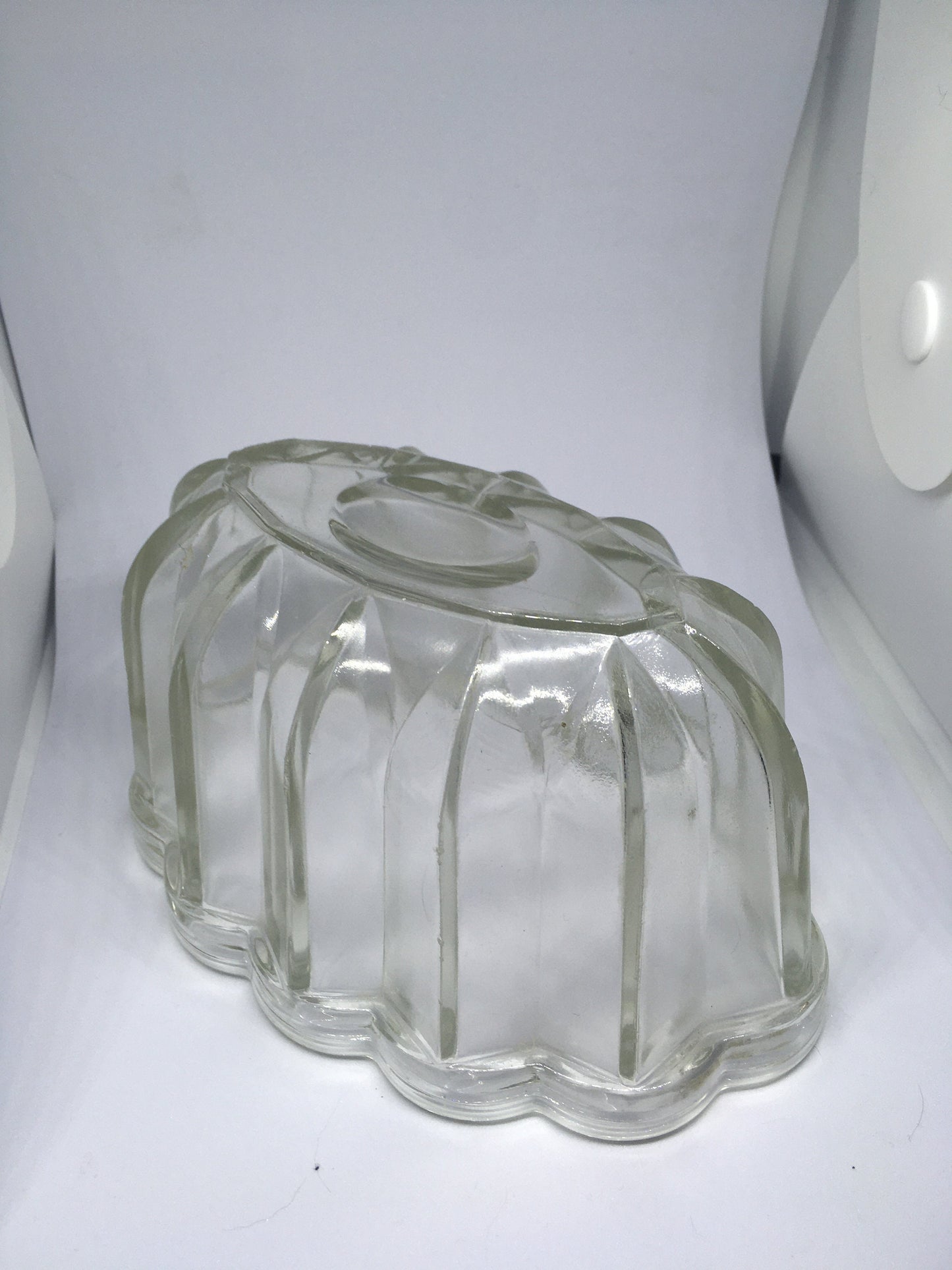 Vintage glass jelly mould. Clear pressed glass with scalloped edge. 10cm deep 16cm long.