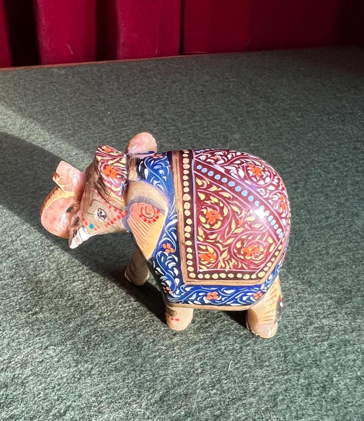 Decorative hand carved soapstone elephant in ceremonial dress.