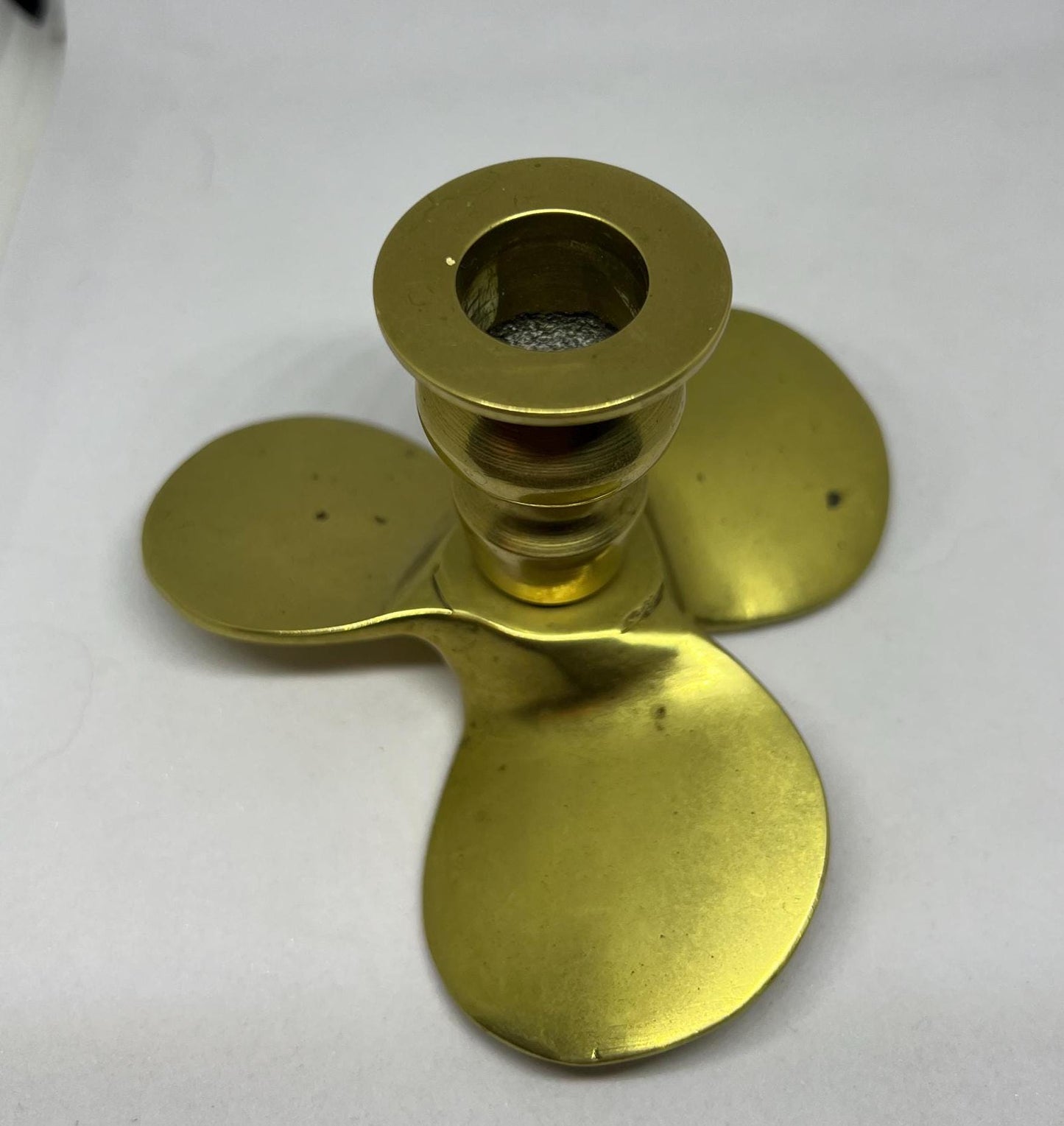 Brass candle stick Propellor shaped candle holder.