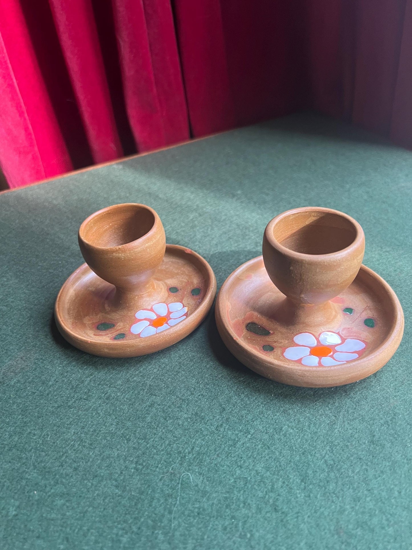 Pair of ceramic egg cups. Studio pottery brown glazed egg cups with integral saucers,