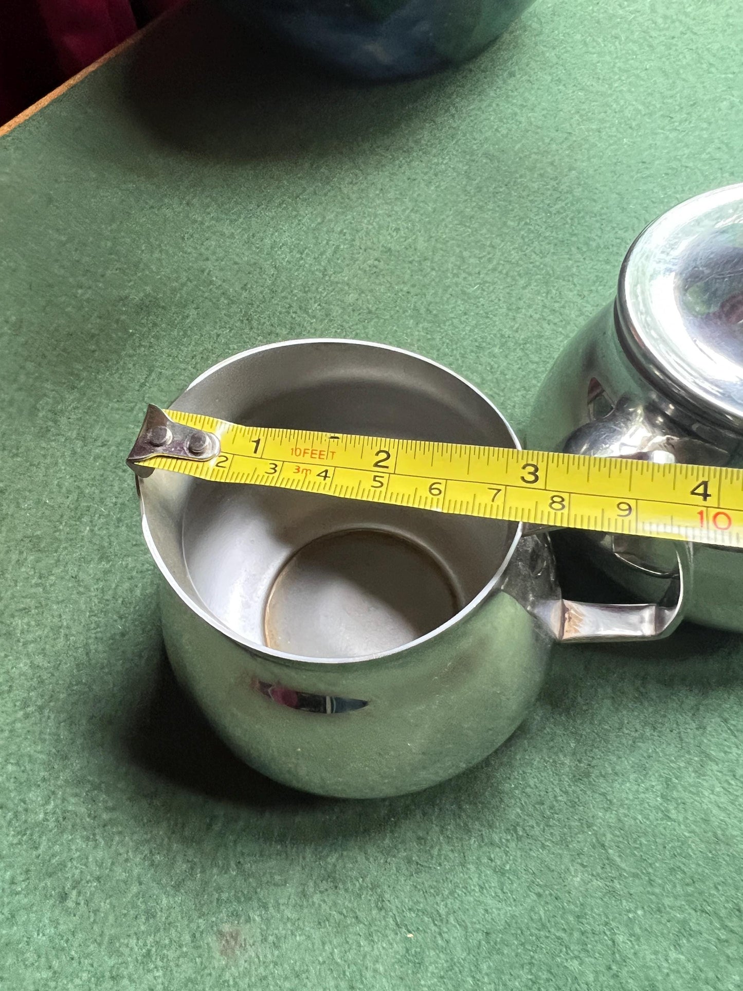 Stainless Steele lidded sugar bowl and creamer. Stamped Bramah of Sheffield Made in England.