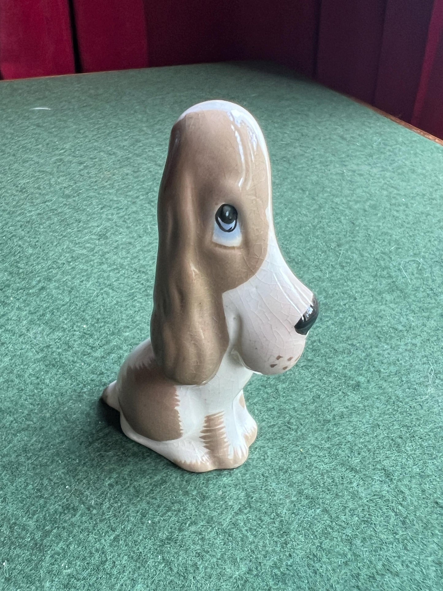Ceramic sad hound dog figurine. Stamped Szeiler.