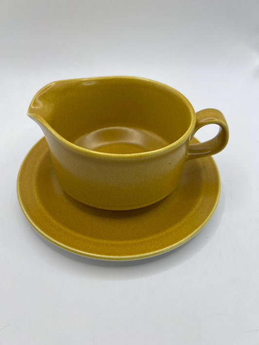 Mustard yellow ceramic gravy sauce boat and saucer. Stamped Glo-white Ironstone Alfred Meakin England.