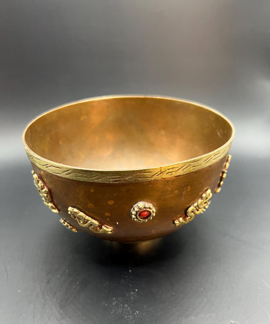 Decorative footed copper bowl with applied dragon detail and semi precious stone embellishments.
