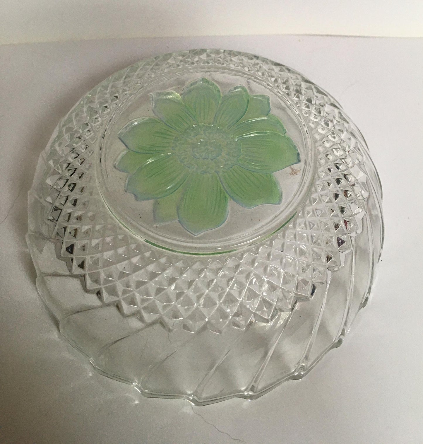 Vintage pressed glass trinket ring dish with green flower detail.