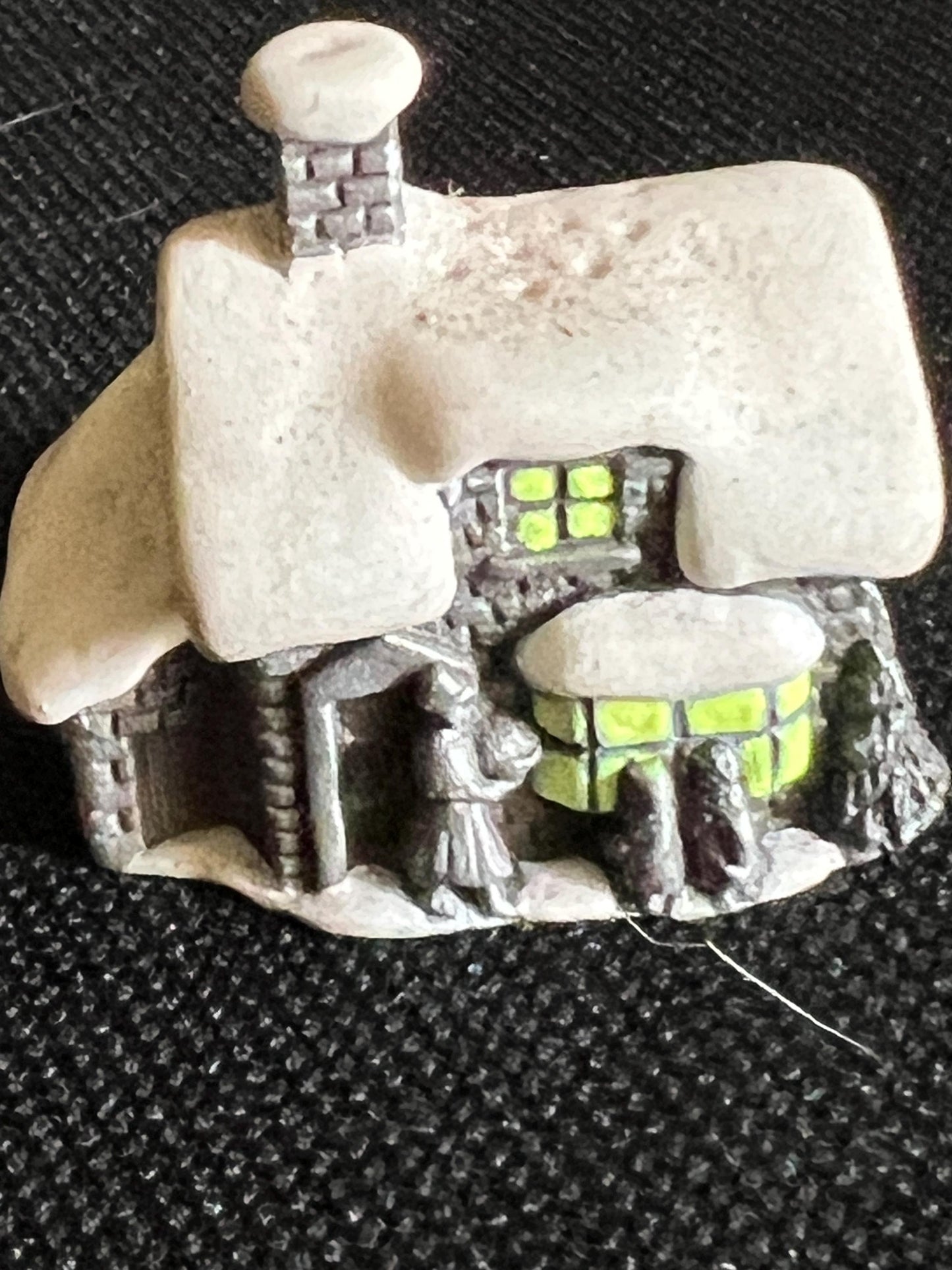 Miniature solid metal cast ornament snow covered Victorian shop.
