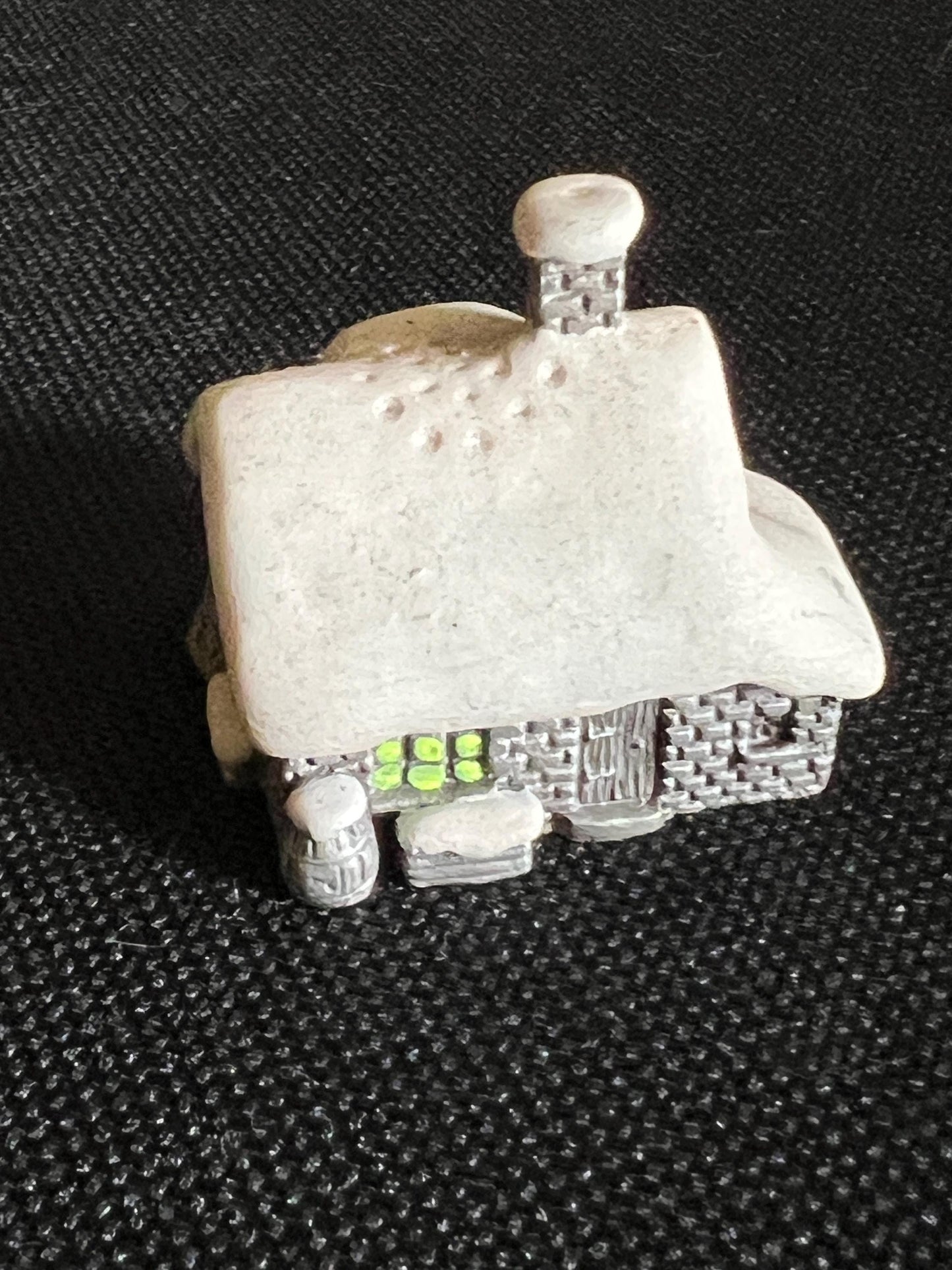 Miniature solid metal cast ornament snow covered Victorian shop.