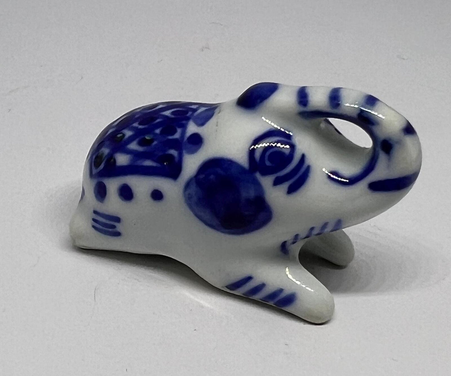 Lucky trunk up sitting elephant ornament. Blue white vintage elephant.