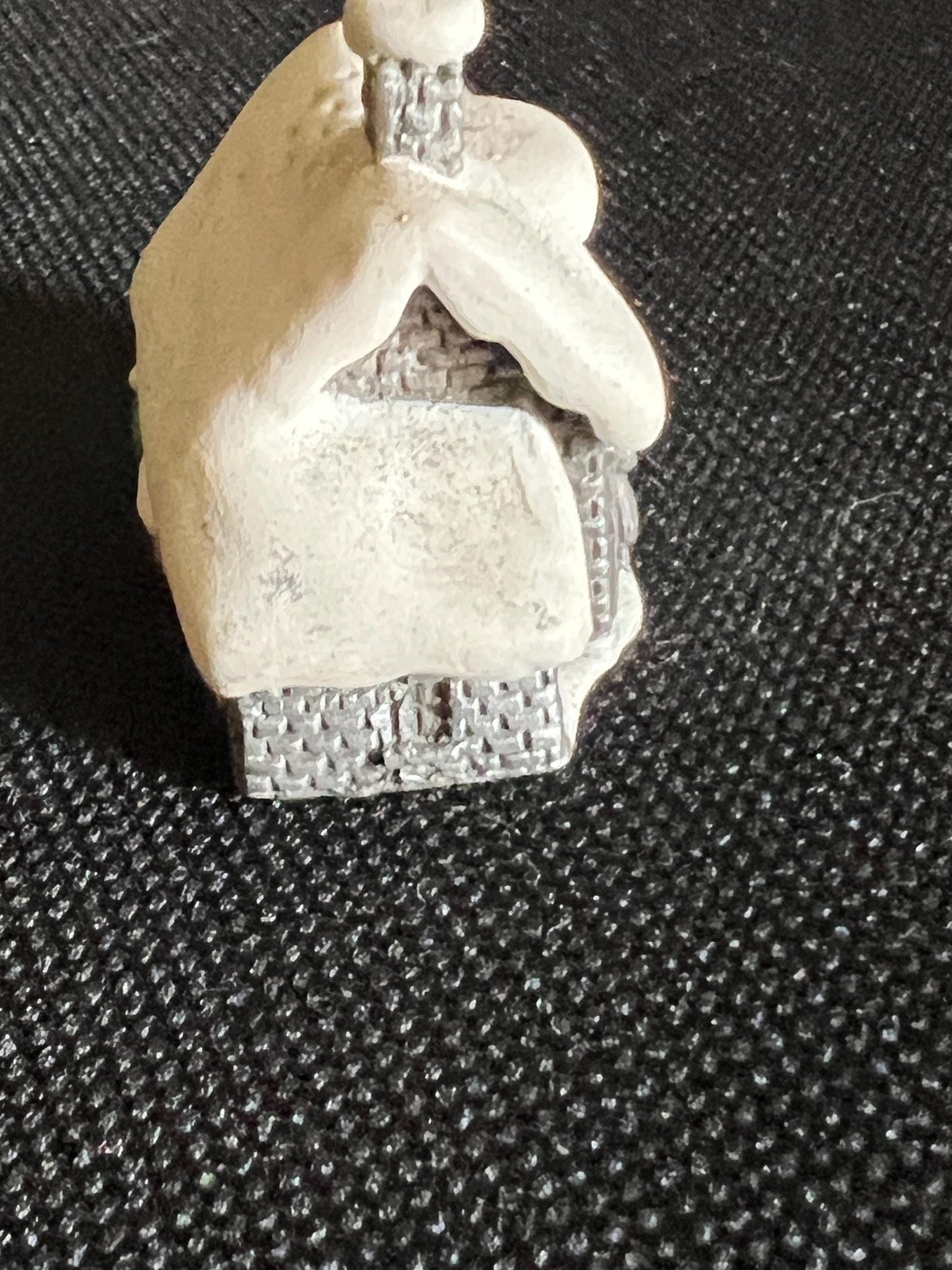 Miniature solid metal cast ornament snow covered Victorian shop.