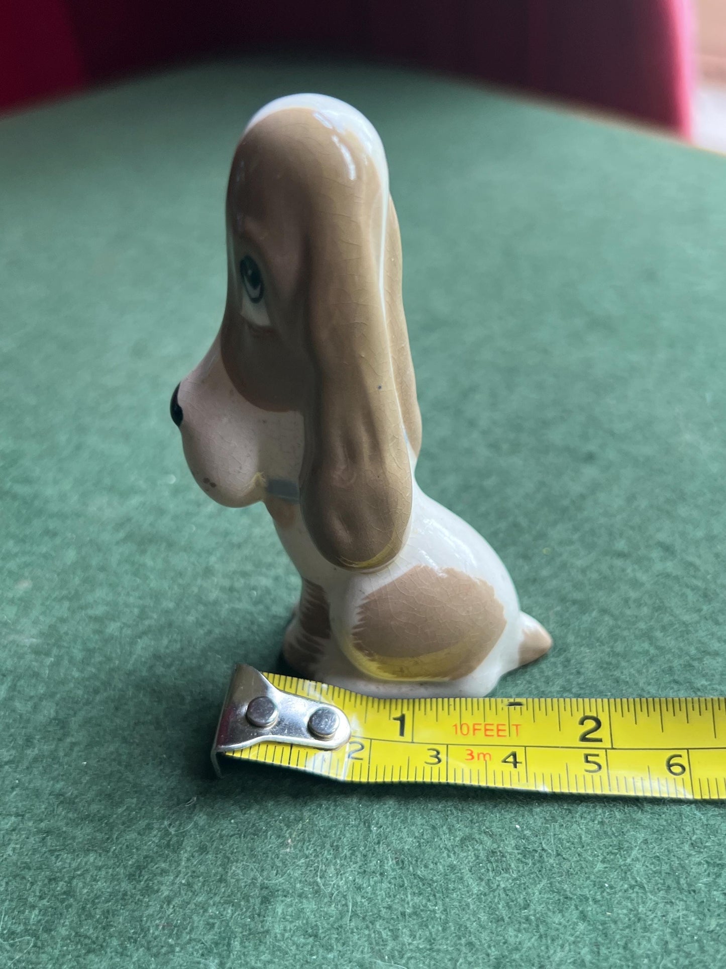 Ceramic sad hound dog figurine. Stamped Szeiler.