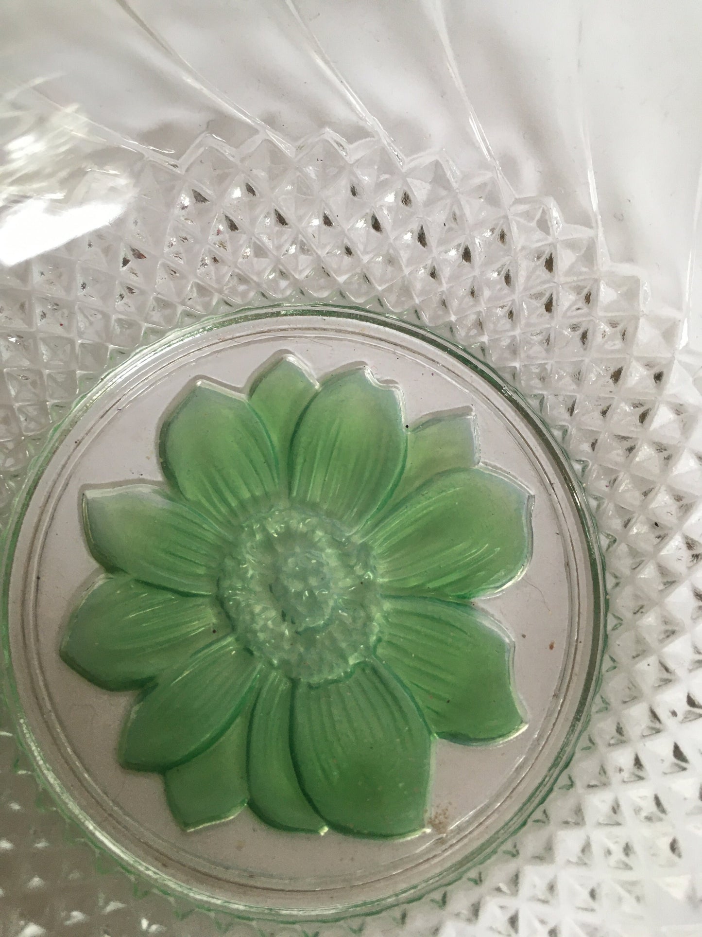 Vintage pressed glass trinket ring dish with green flower detail.