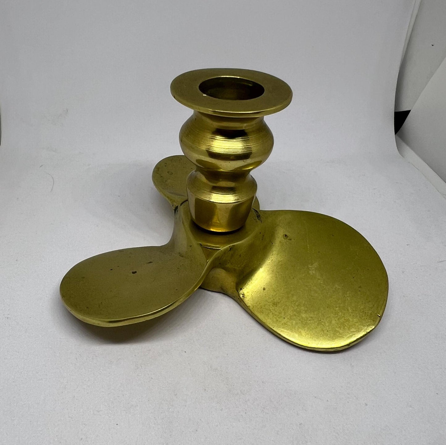 Brass candle stick Propellor shaped candle holder.