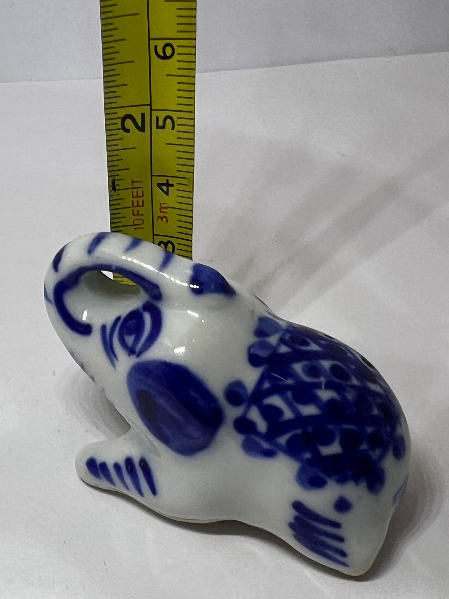 Blue white ceramic elephant figurine. Lucky trunk up sitting elephant ornament.