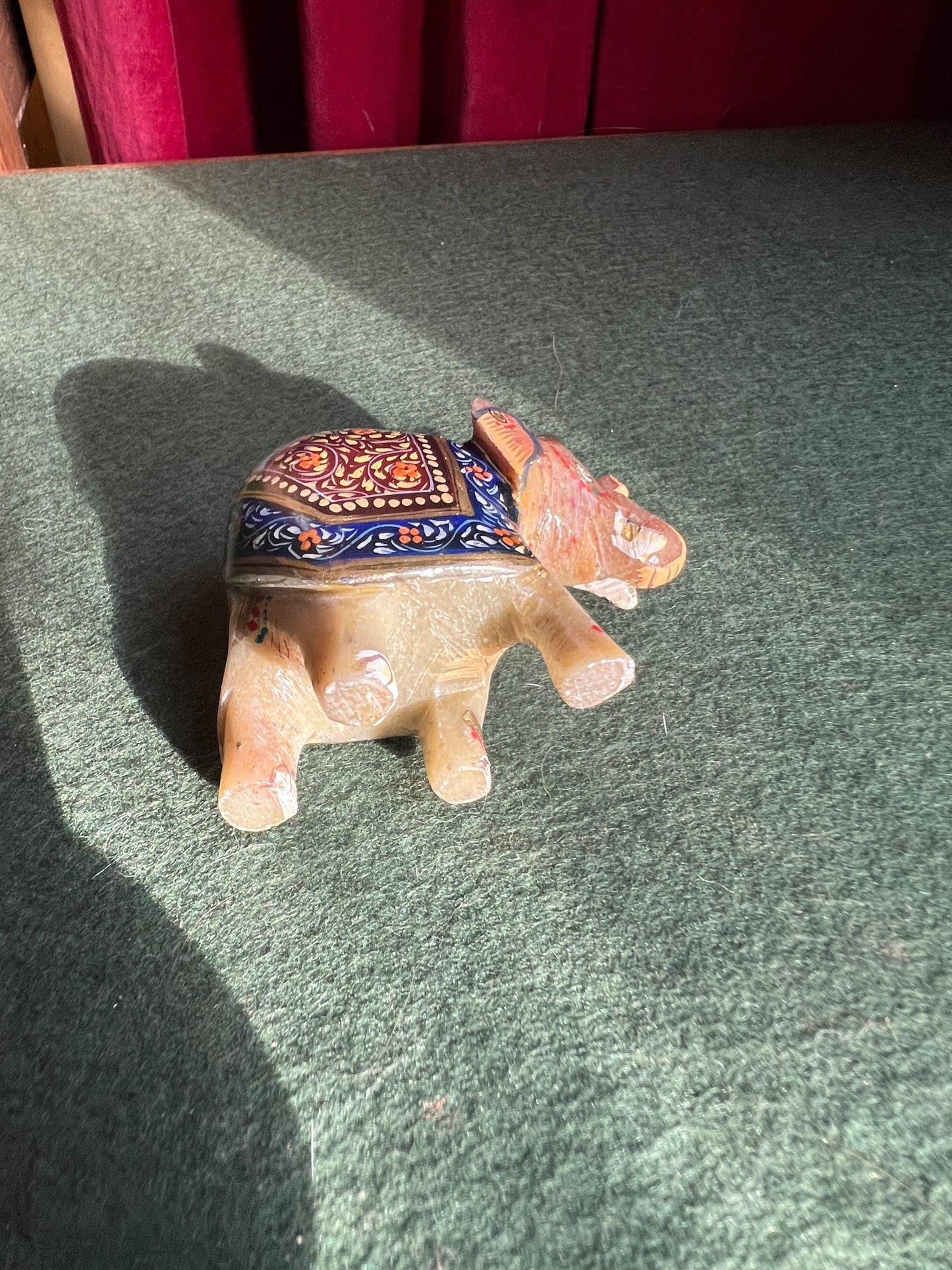 Decorative hand carved soapstone elephant in ceremonial dress.