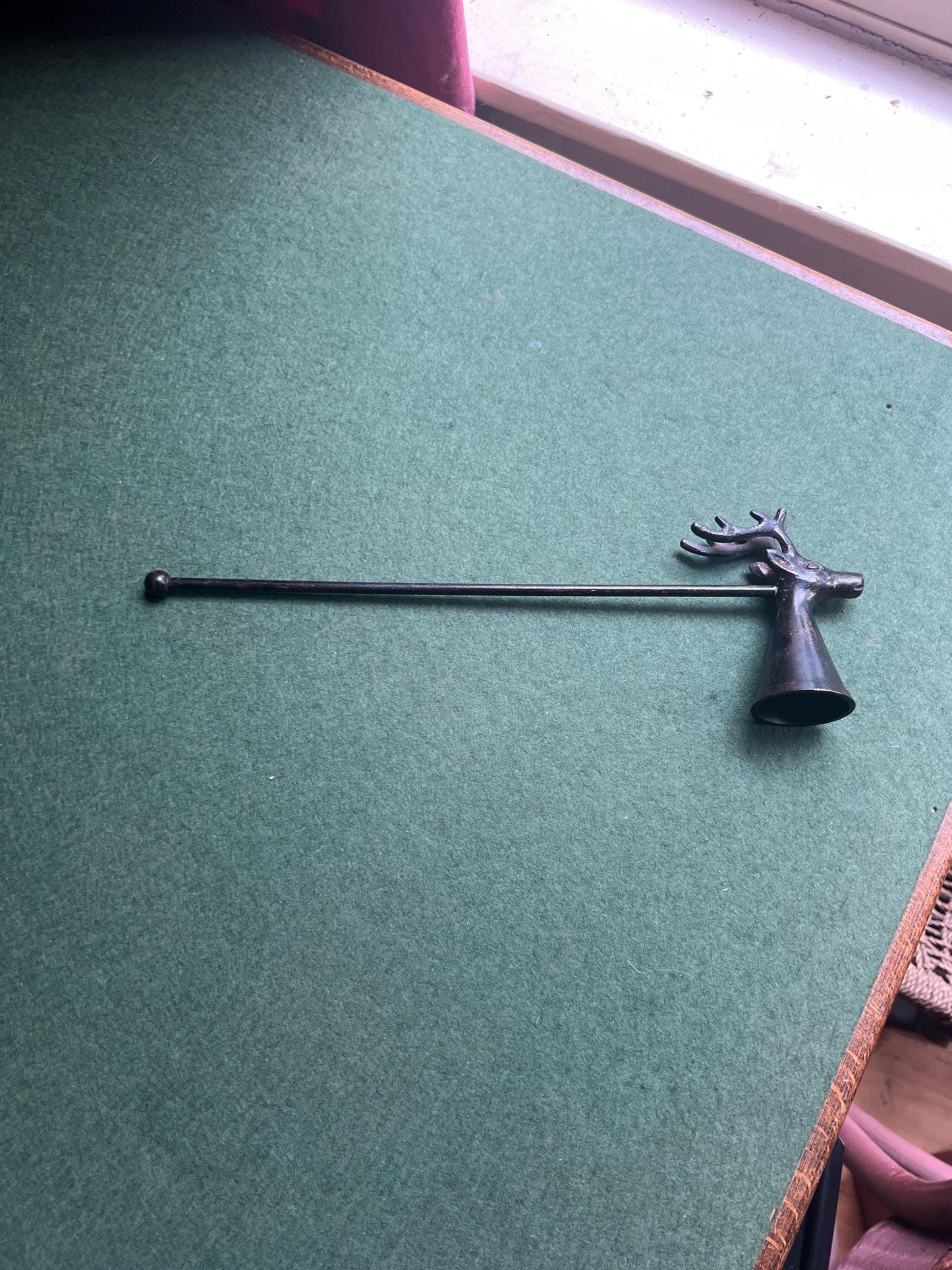 Vintage stag head candle snuffer. Black metal long handled candle extinguisher.