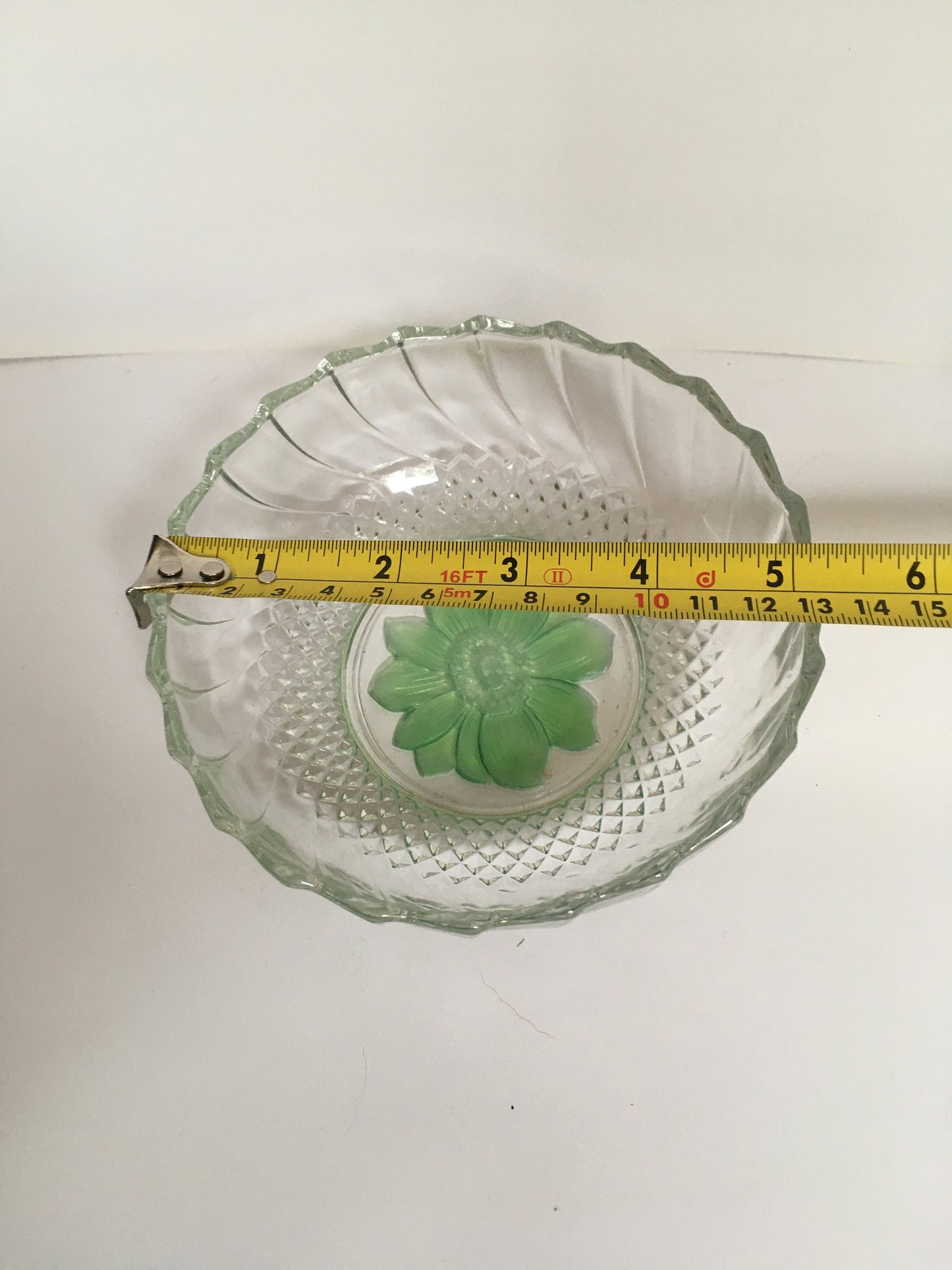 Vintage pressed glass trinket ring dish with green flower detail.