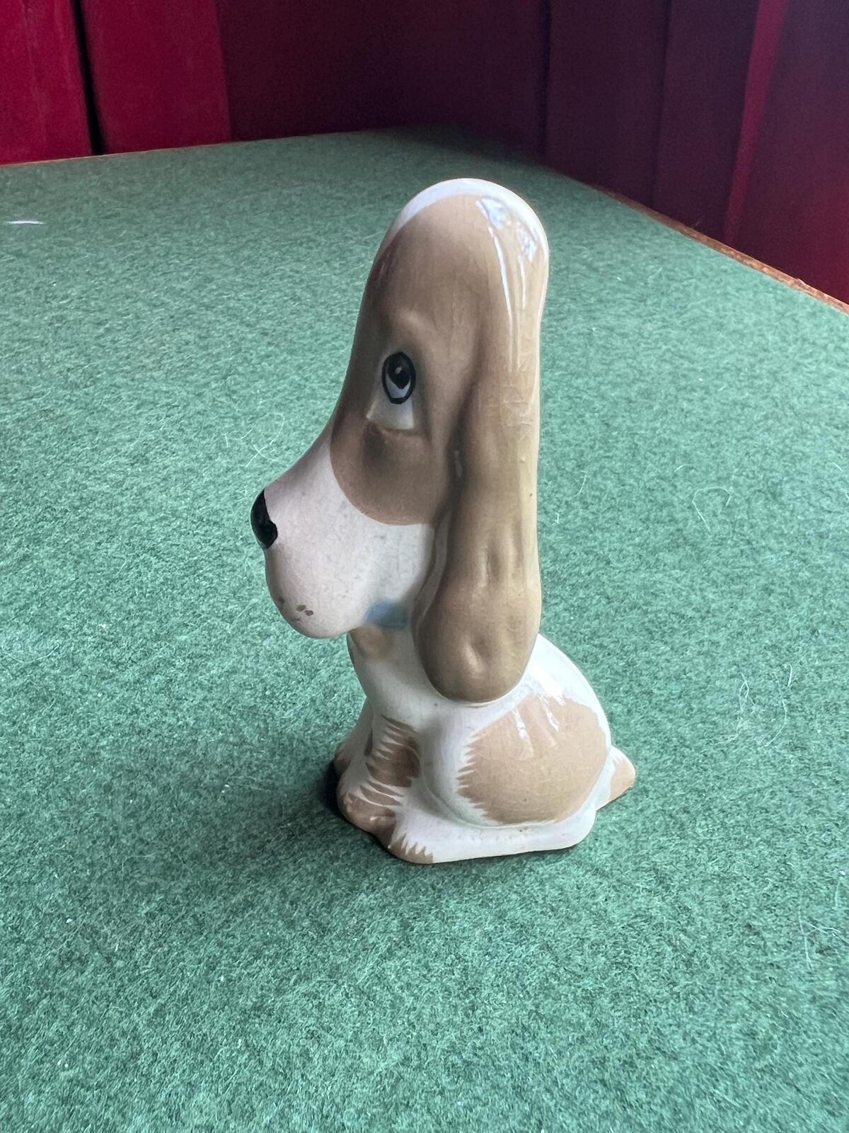 Vintage ceramic sad hound dog figurine. Stamped Szeiler