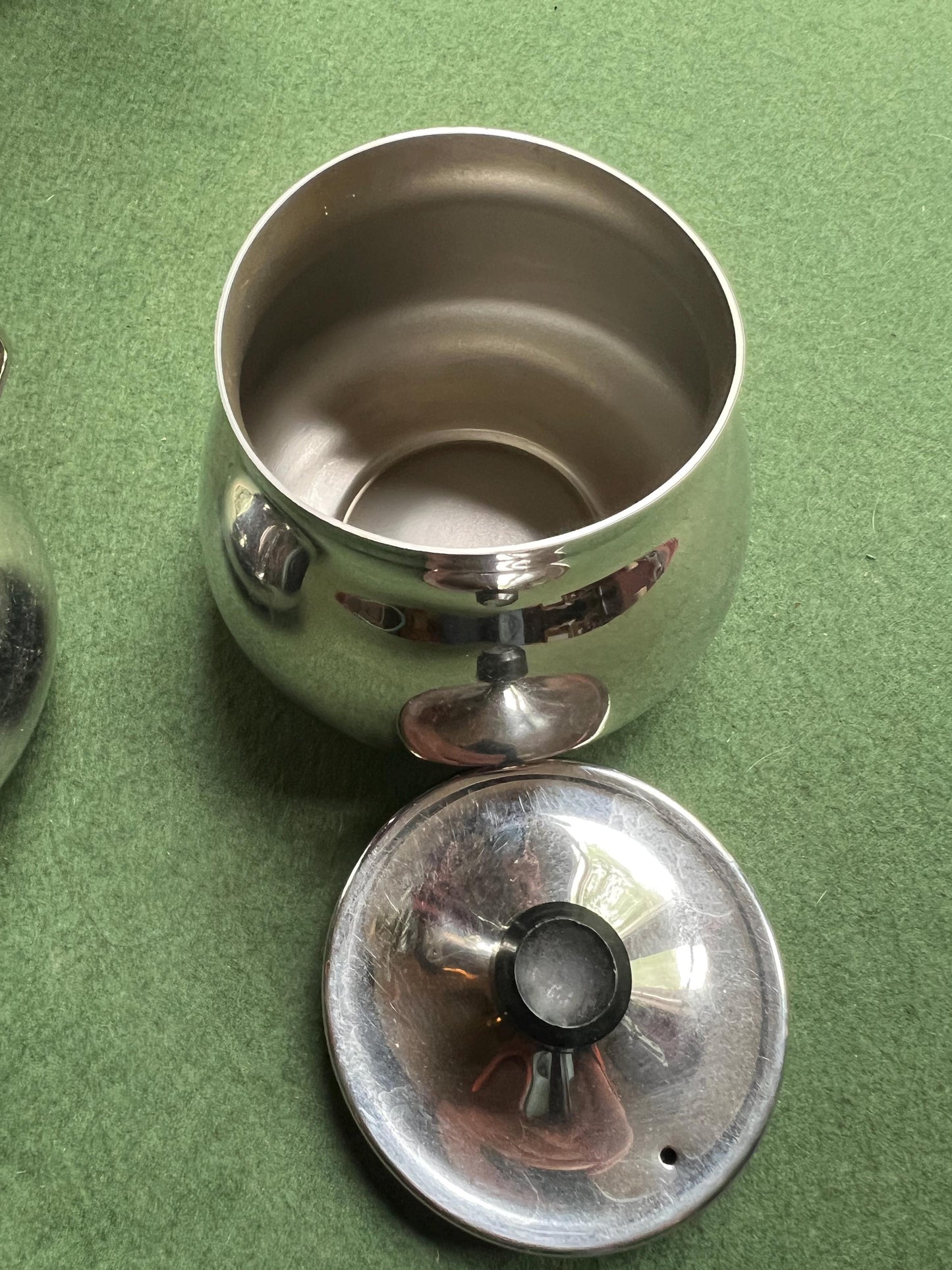 Stainless Steele lidded sugar bowl and creamer. Stamped Bramah of Sheffield Made in England.