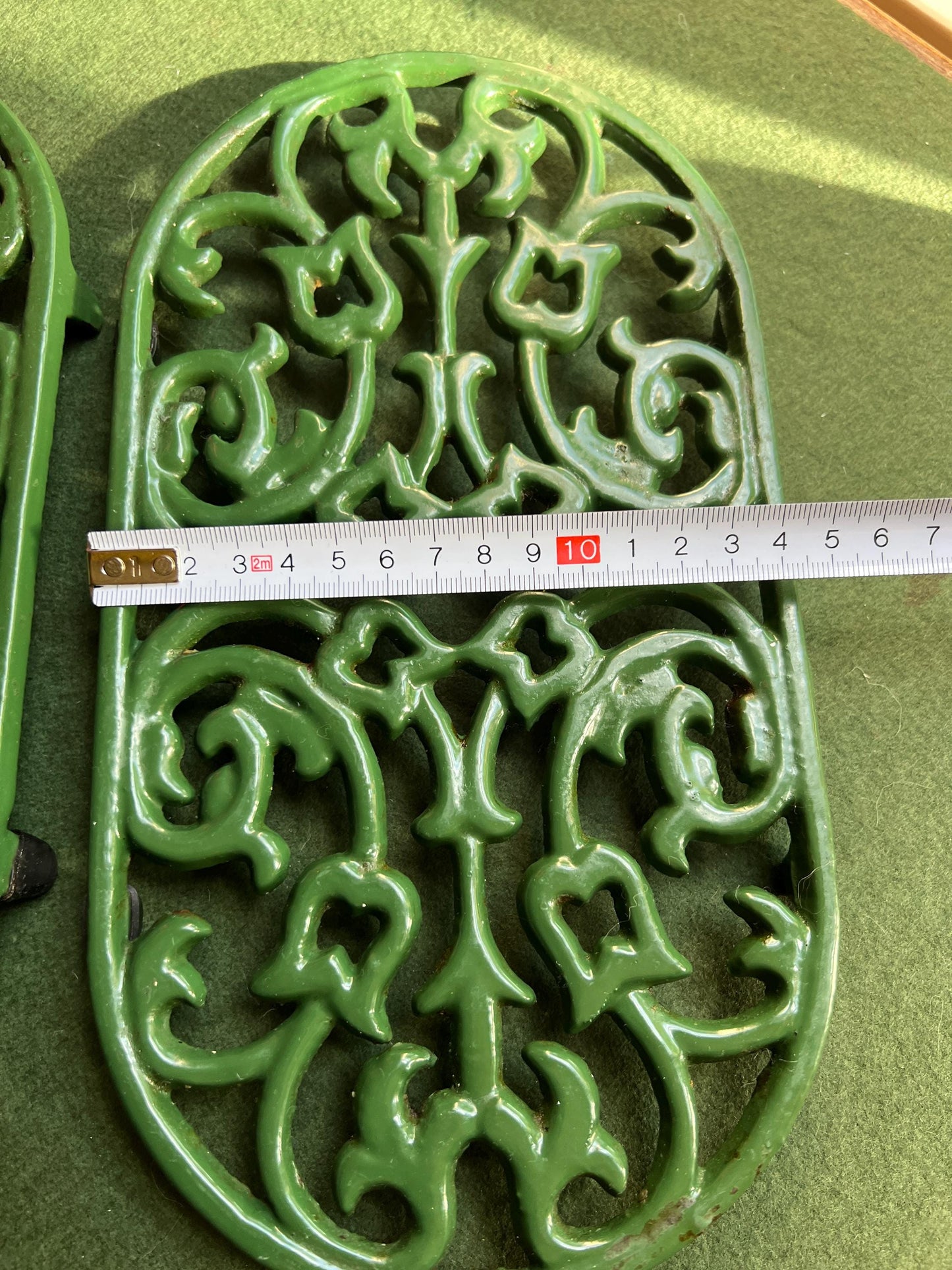 Vintage cast iron trivets. Large Oval green 4 footed trivets. 2 available. Sold separately.