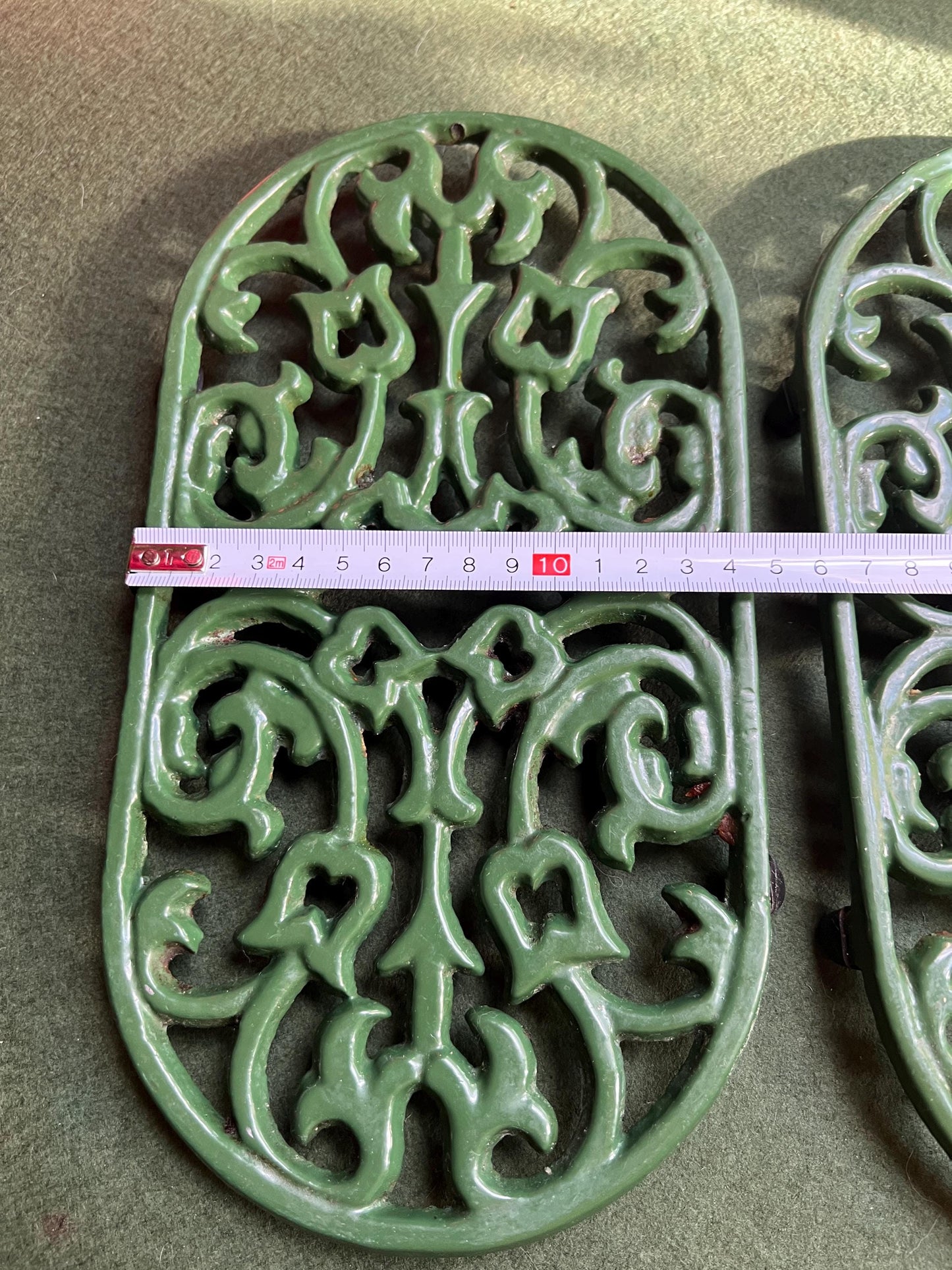 Vintage cast iron trivets. Large Oval green 4 footed trivets. 2 available. Sold separately.