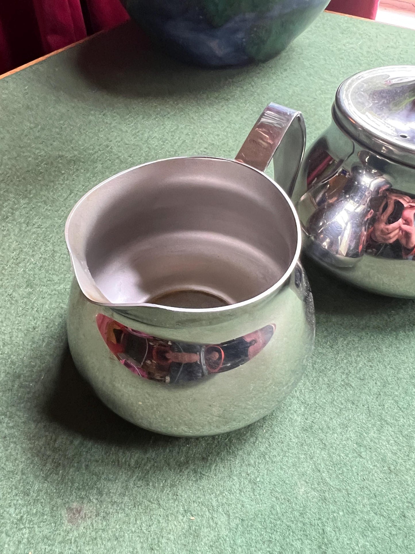 Stainless Steele lidded sugar bowl and creamer. Stamped Bramah of Sheffield Made in England.