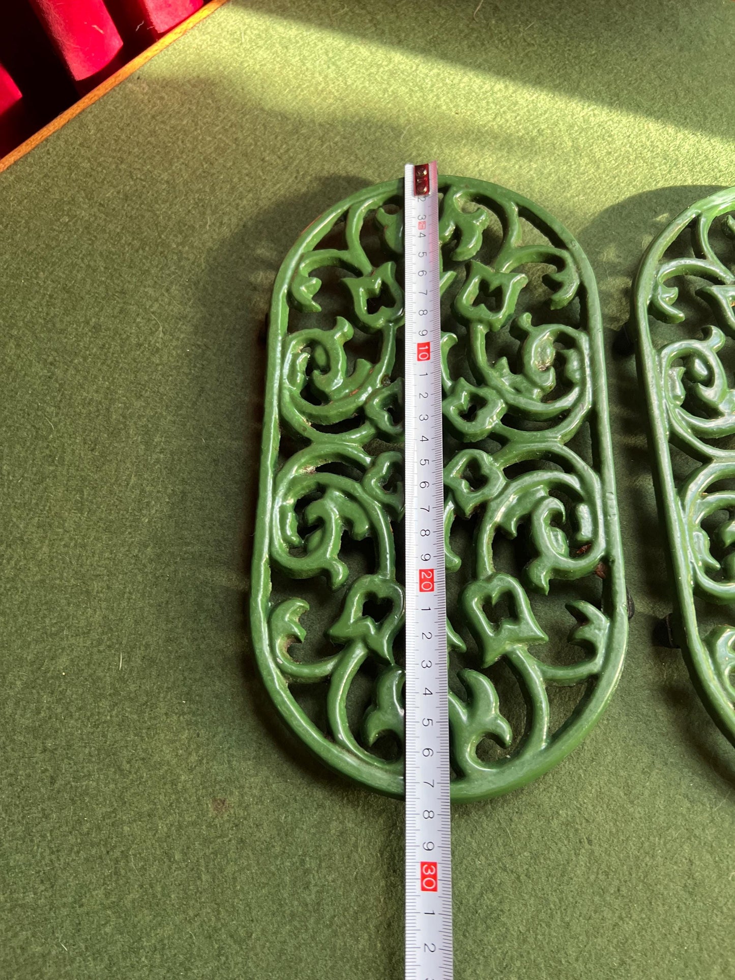 Vintage cast iron trivets. Large Oval green 4 footed trivets. 2 available. Sold separately.
