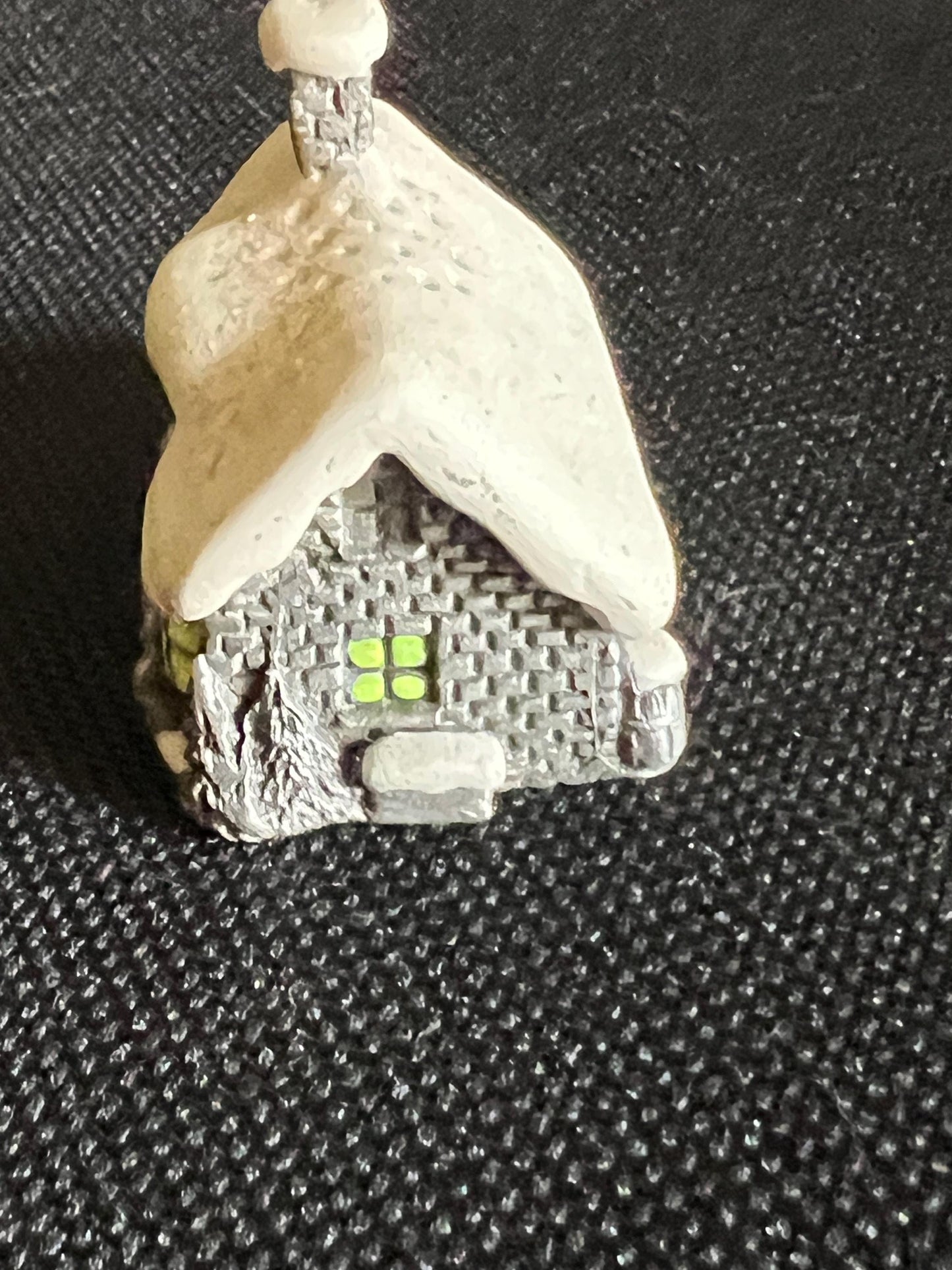 Miniature solid metal cast ornament snow covered Victorian shop.