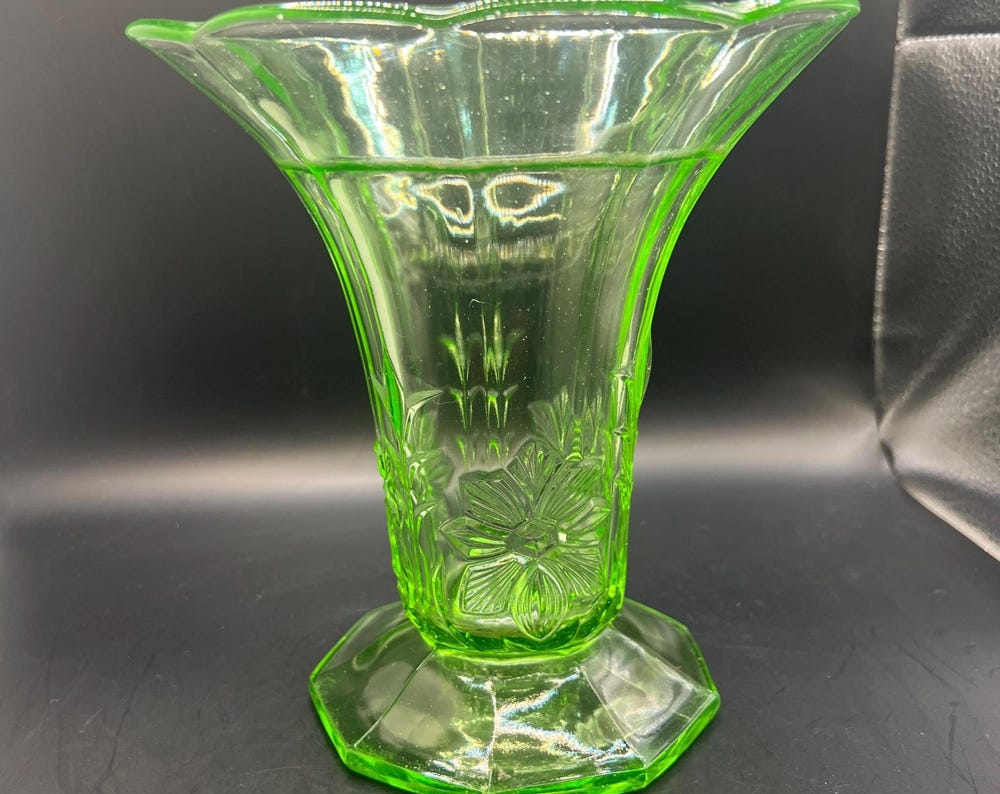 Vintage antique uranium glass vase. Octagonal base with flared ruffle rim and floral imprint.